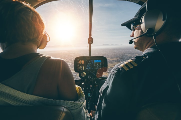 Interior of a helicopter cockpit showing the pilots