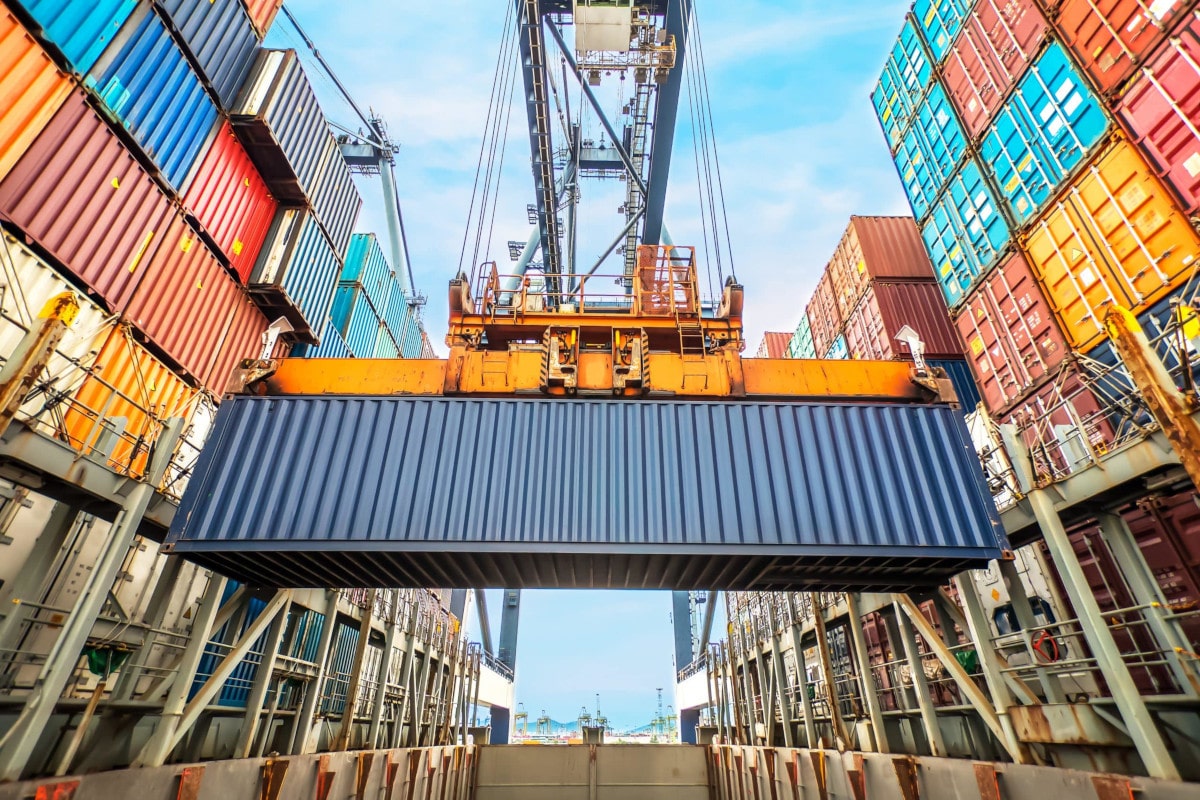 Crane at a port holding a large shipping container