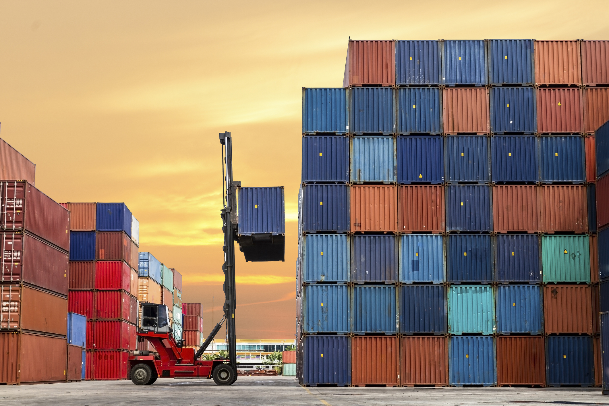 Crane lifting up shipping container in port