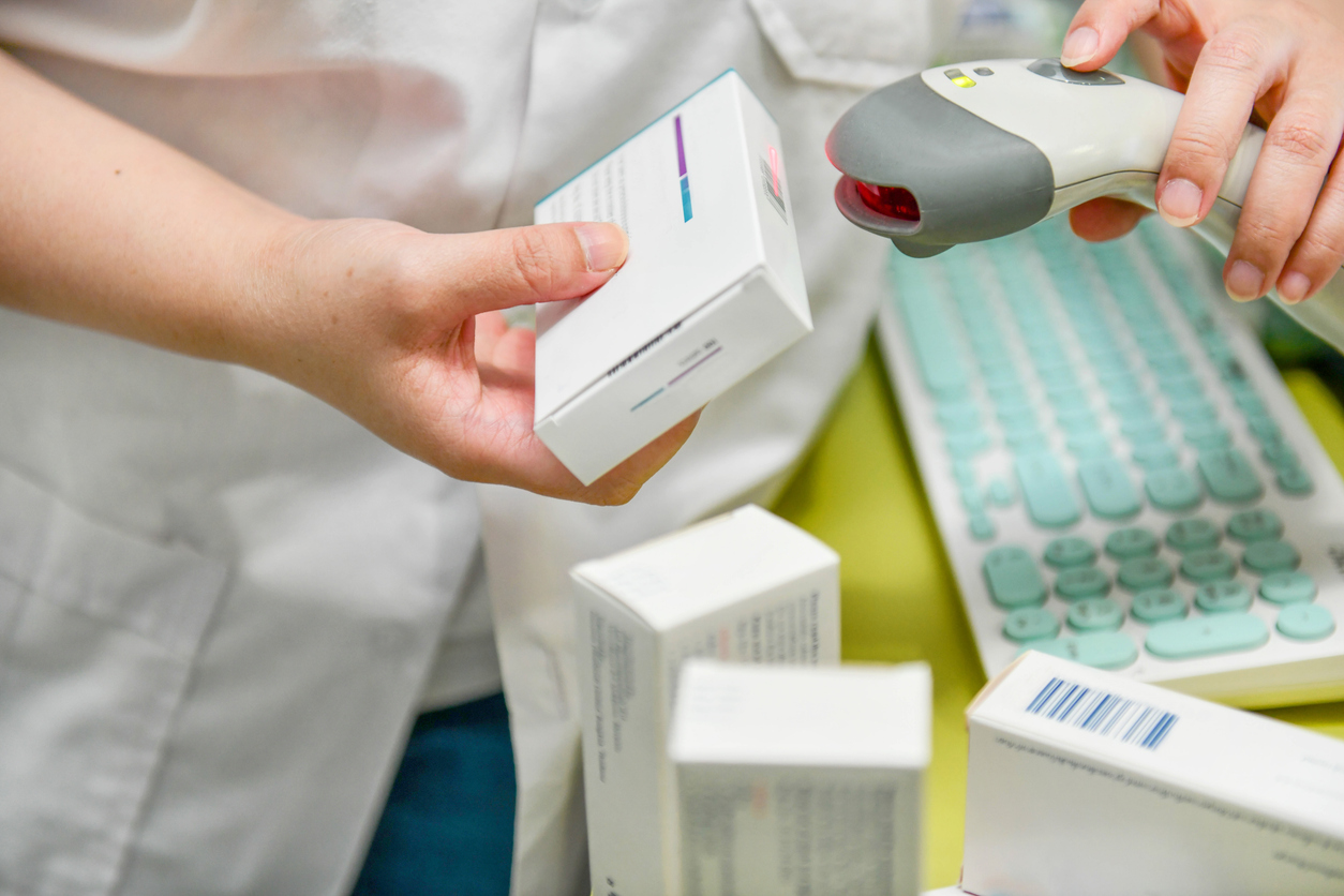 Pharmacist scanning barcode on a medication at the pharmacy