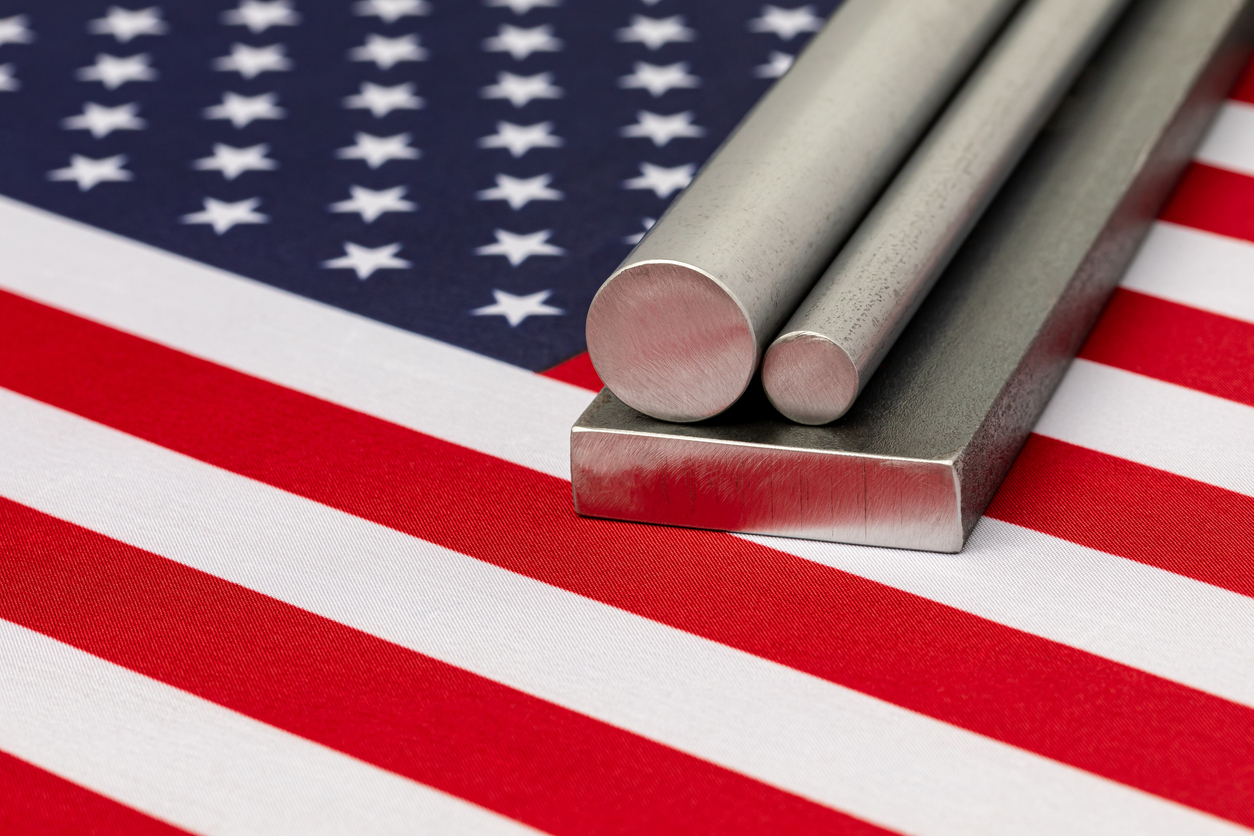 Steel stock subject to Section 301 tariffs laying on the flag of the United States